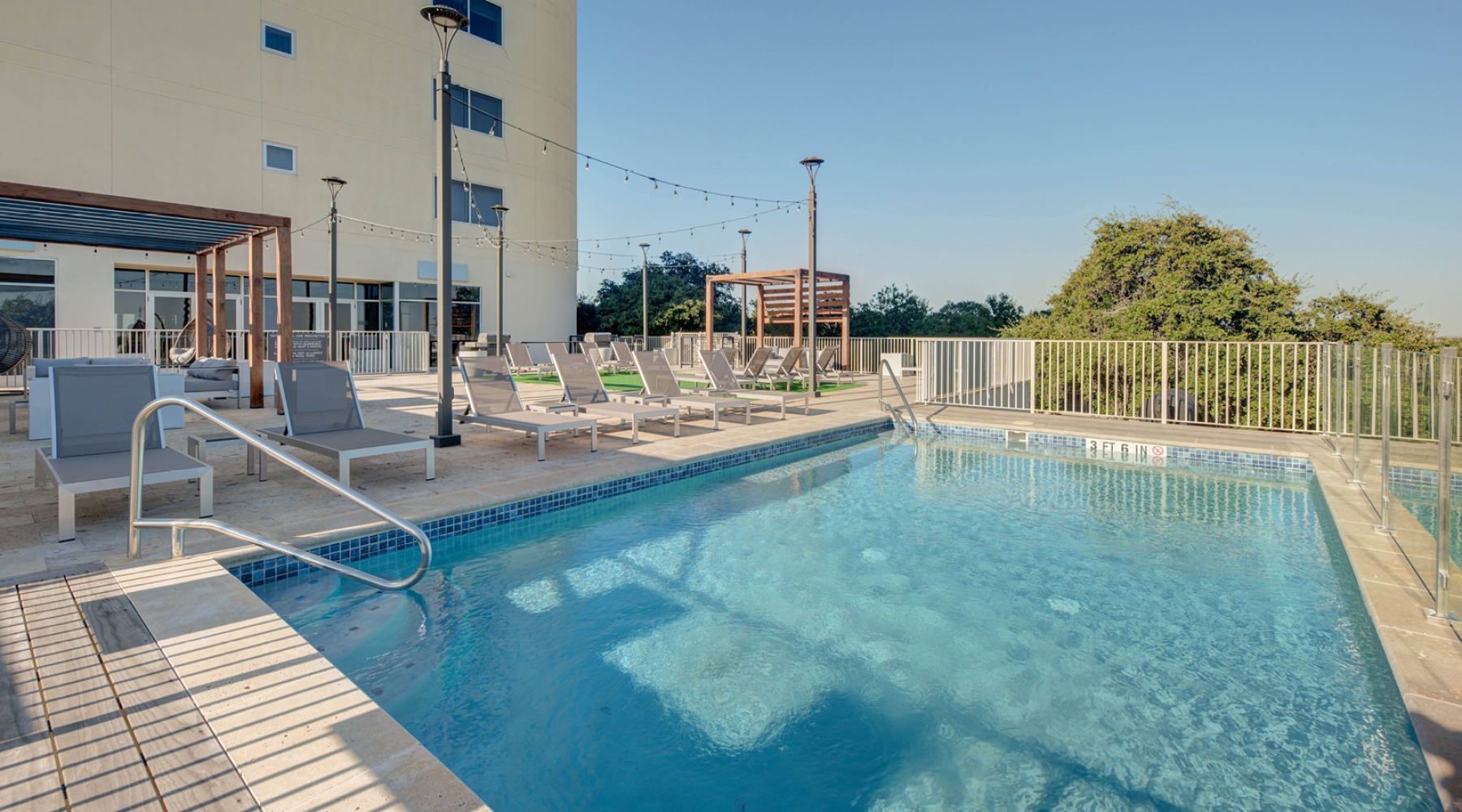 parallax image Resort-style swimming pool with lounge seating